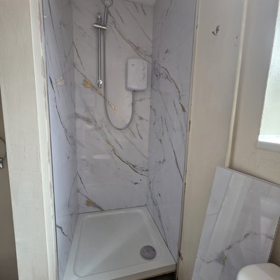 Finished shower enclosure after plumbing work