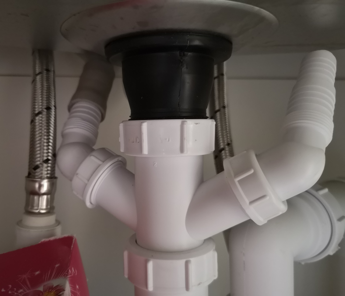 Washing machine waste spigot under a sink